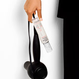Hand holding a hair dryer and Giovanni Rapid Blow-Dry Shield & Style Spray