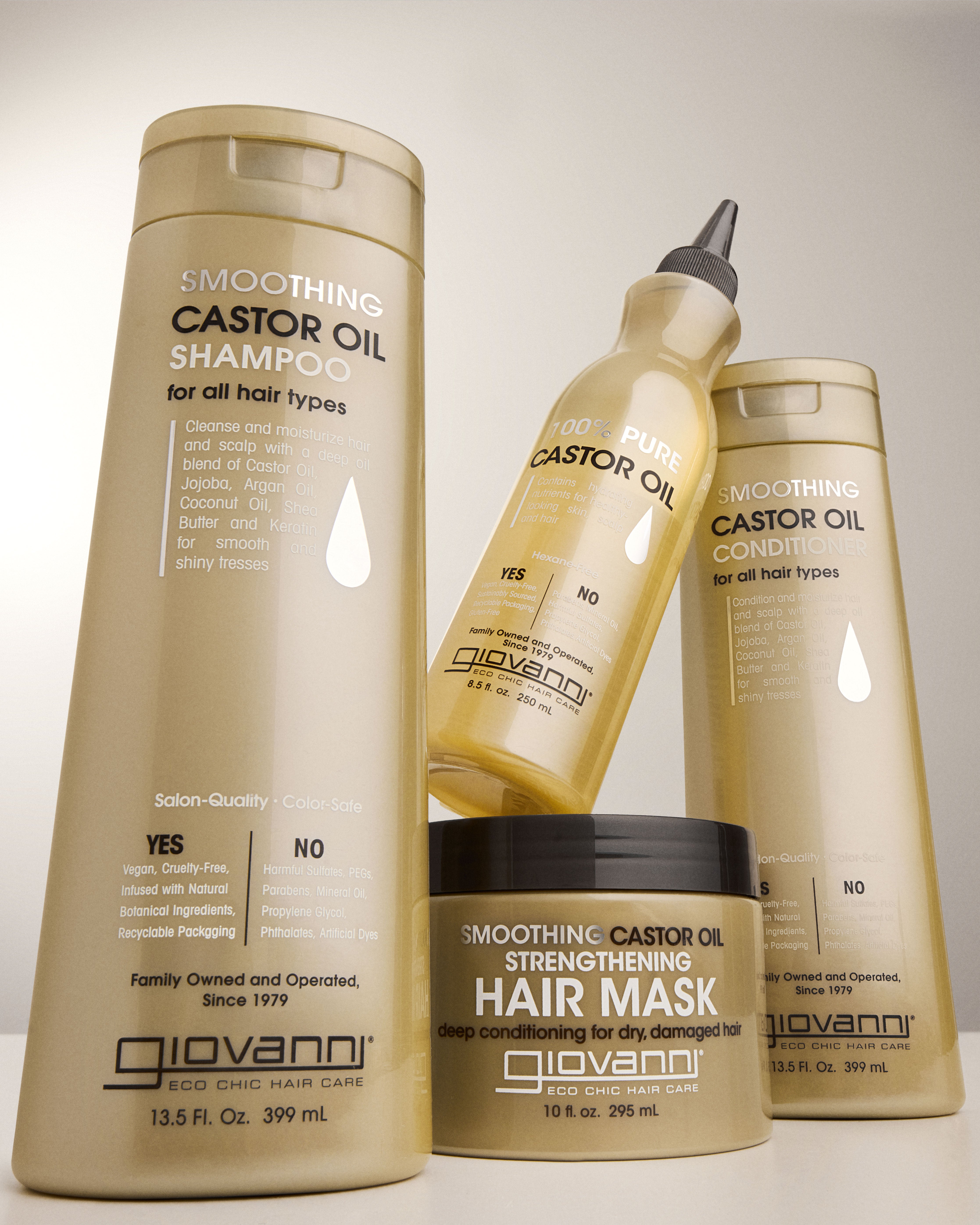Giovanni Smoothing Castor Oil hair care products including shampoo, conditioner, and hair mask on a neutral background.