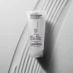 Giovanni hair thickener bottle on a textured white surface