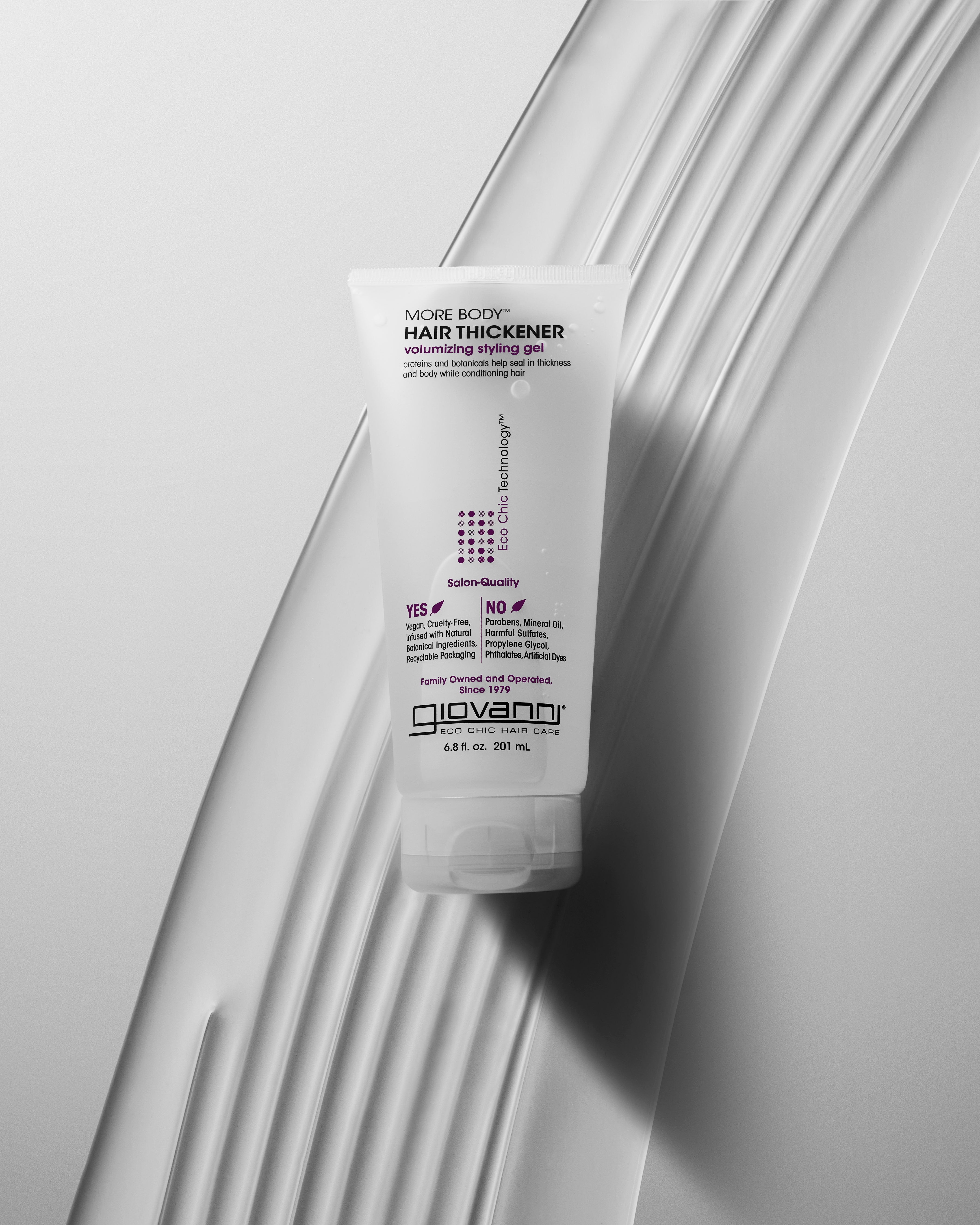 Giovanni hair thickener bottle on a textured white surface
