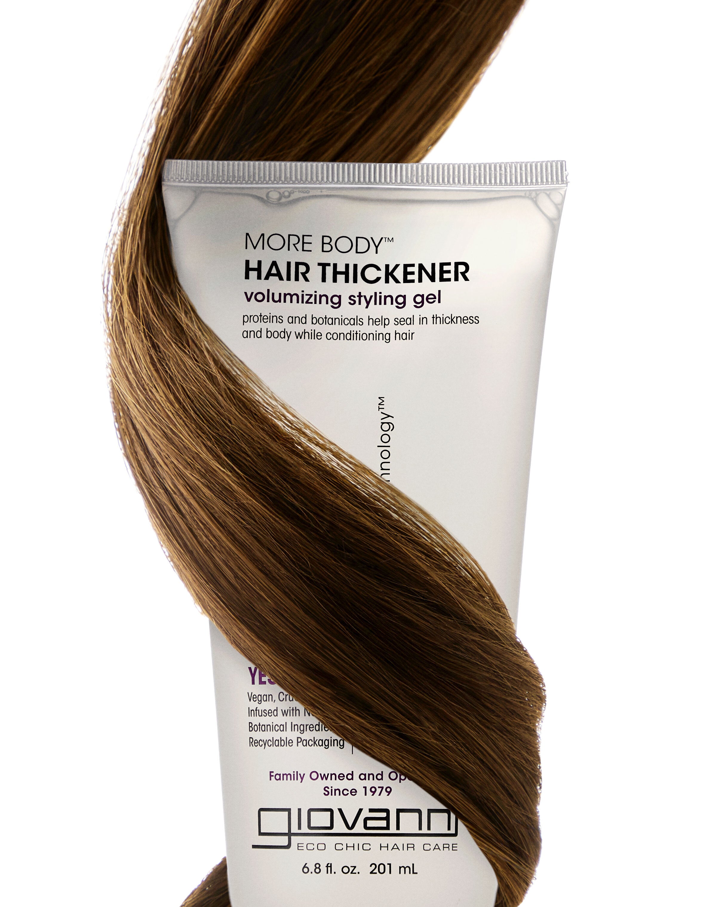 Giovanni hair thickener tube with brown hair wrapped around it on a white background
