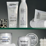 Giovanni hair care products on a glass shelf with a neutral background