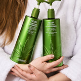 Two bottles of Giovanni Hemp Hydrating Shampoo and Conditioner held by a person in a white robe.