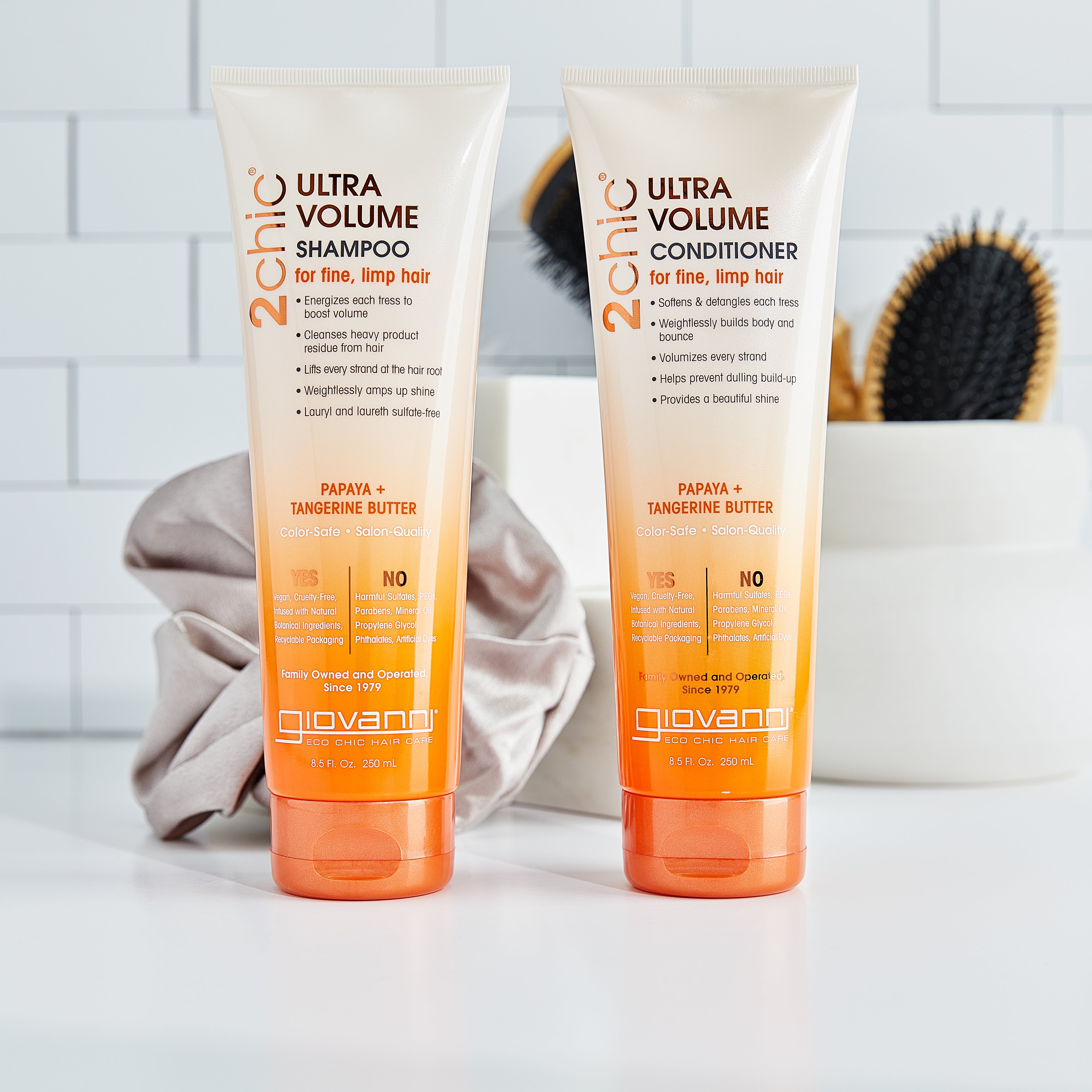 Bottles of Giovanni 2Chic Ultra Volume Shampoo and Conditioner in bathroom
