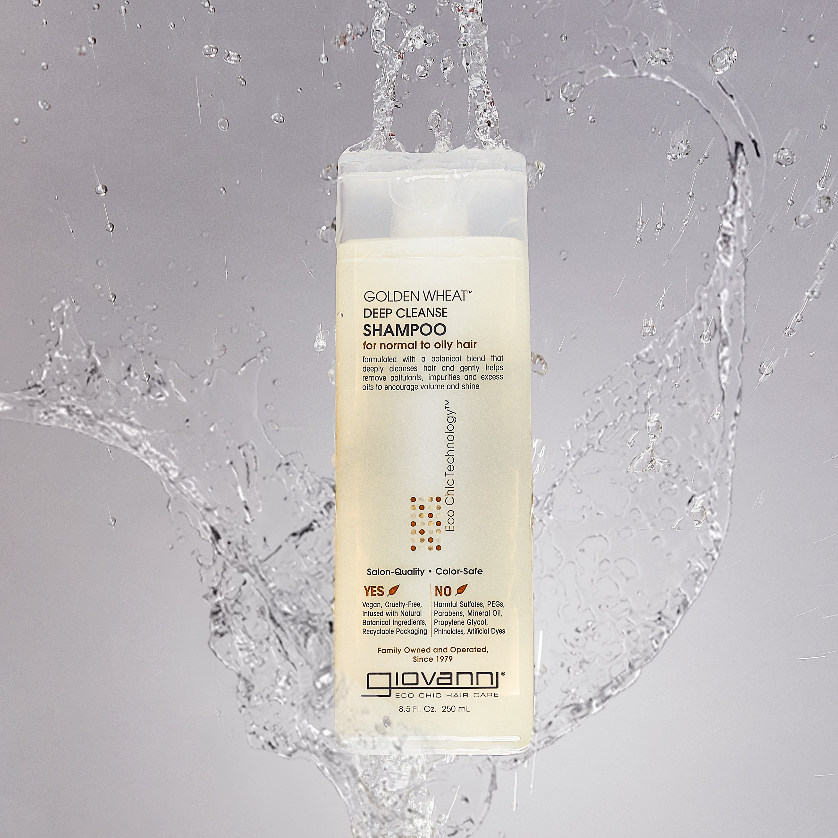 Bottle of Giovanni Golden Wheat Deep Cleanse Shampoo with water splashing
