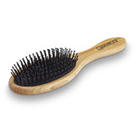 The Giovanni Cosmetics BAMBOO OVAL HAIRBRUSH features a light brown bamboo handle with the Giovanni logo in black, black bristles, and rounded tips. This salon-quality, sustainable styling tool is shown on a white background.