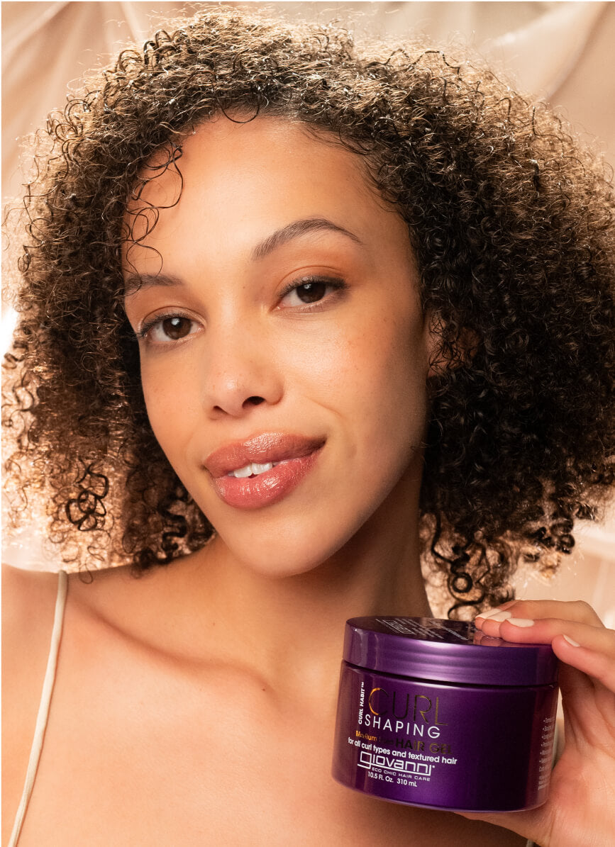 Woman holding jar of Giovanni CURL Shaping Hair Gel