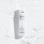 A white bottle of Giovanni Cosmetics SMOOTH AS SILK™ HAIR DETANGLING SPRAY rests on a rippled white surface with soft light reflections, creating a clean, fresh look—ideal for silky, detangled hair.