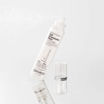 A white spray bottle labeled Giovanni Cosmetics SMOOTH AS SILK™ HAIR DETANGLING SPRAY mists on a white background, promising tangle-free hair. Its transparent cap rests beside the bottle.