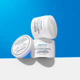 Three white jars of Giovanni Cosmetics FRIZZ BE GONE™ INTENSIVE ANTI-FRIZZ CONDITIONING HAIR MASK are stacked against a blue and white background, highlighting this deep conditioning mask for frizz control and intense hydration.