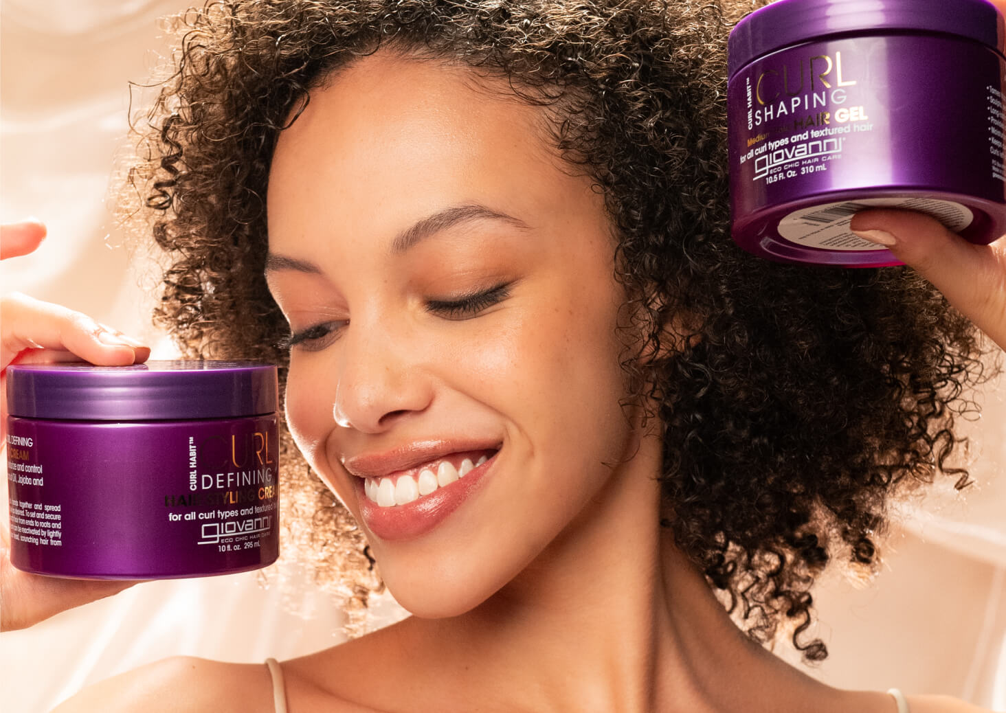 Woman holding jars of Giovanni Curl Defining Hair Styling Cream and Curl Shaping Hair Gel