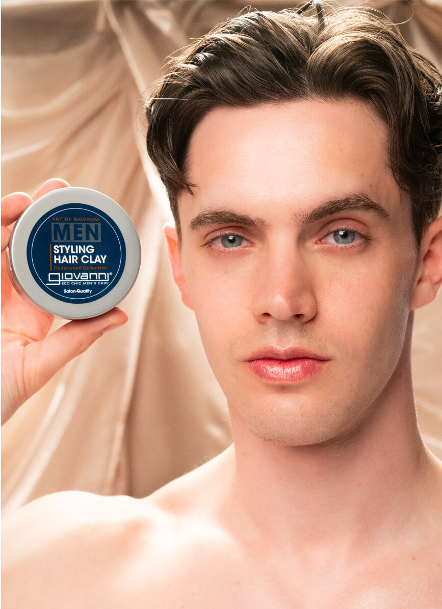 Man holding jar of Giovanni Men Styling Hair Clay
