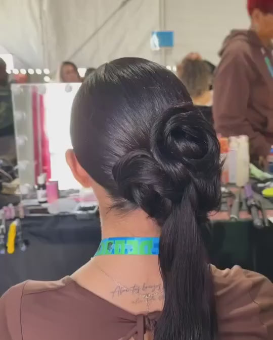 Hair stylist back stage doing an updo using a hair gel