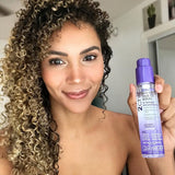 Woman holding bottle of Giovanni 2Chic Repair Super Potion Hair Oil Serum