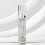 A clear bottle of Giovanni Cosmetics L.A. HOLD™ HAIR SPRITZ stands upright on a white surface against a soft gray background, displaying its visible label and color-safe, salon-quality hair spray inside.