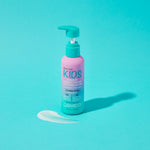 A pink and blue bottle of Giovanni Cosmetics ECO CHIC® KIDS LEAVE-IN CONDITIONING & STYLING ELIXIR sits on a bright aqua background, with a small pump of product beside it, promising tangle-free, easy styling.