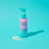 A pink and blue bottle of Giovanni Cosmetics ECO CHIC® KIDS LEAVE-IN CONDITIONING & STYLING ELIXIR sits on a bright aqua background, with a small pump of product beside it, promising tangle-free, easy styling.