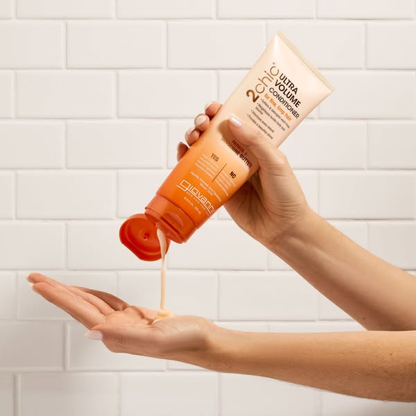 Hands holding Giovanni 2Chic Ultra Volume Conditioner